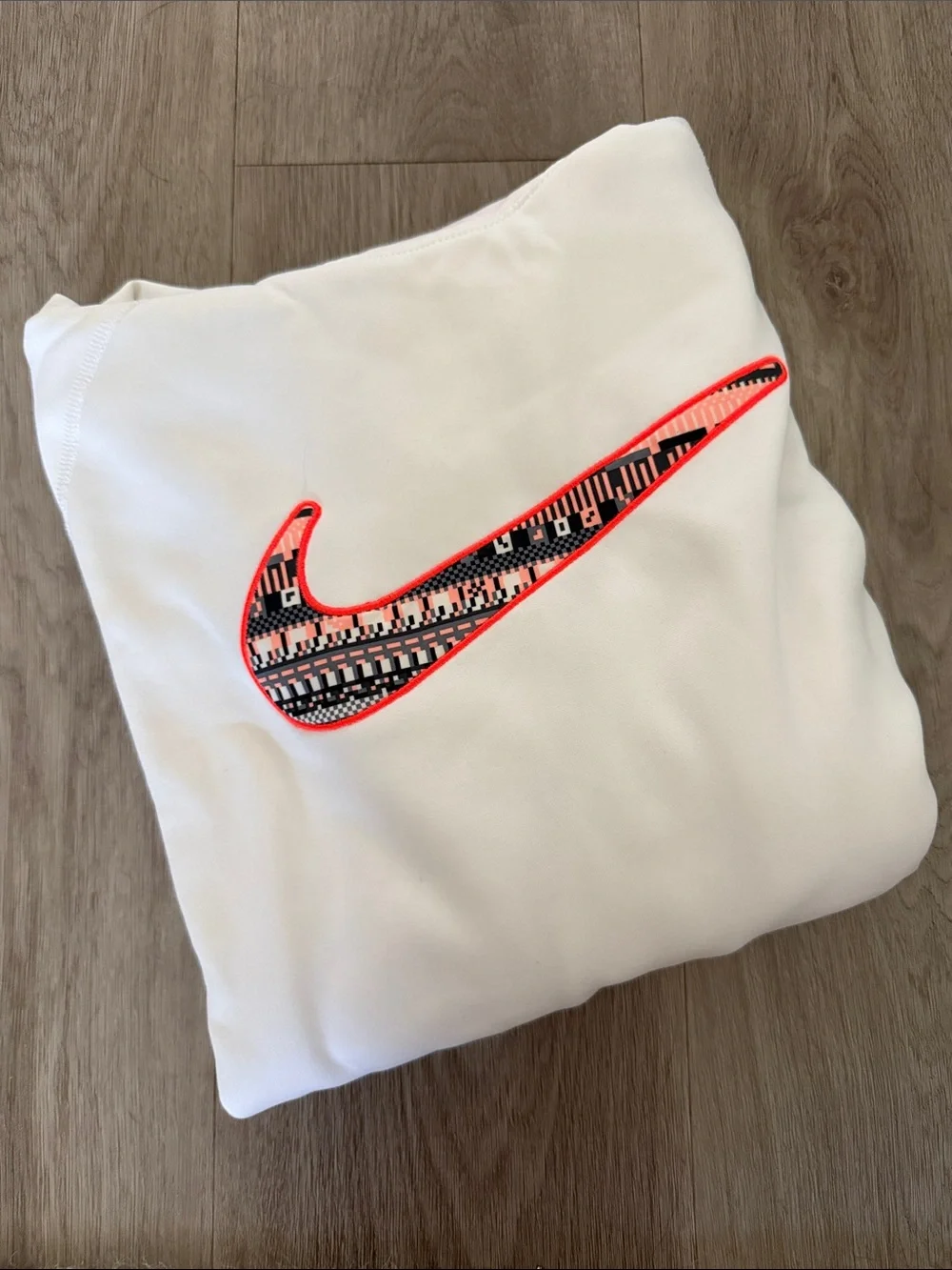Nike White Sweatshirt with Neon Coral-Outlined Patterned Swoosh